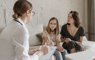 A mother and daughter meet with a family doctor for a summer checkup appointment in Sandpoint, Idaho.