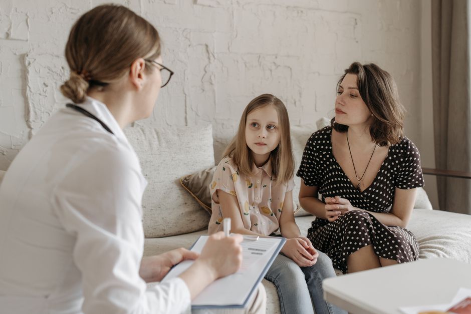 A mother and daughter meet with a family doctor for a summer checkup appointment in Sandpoint, Idaho.