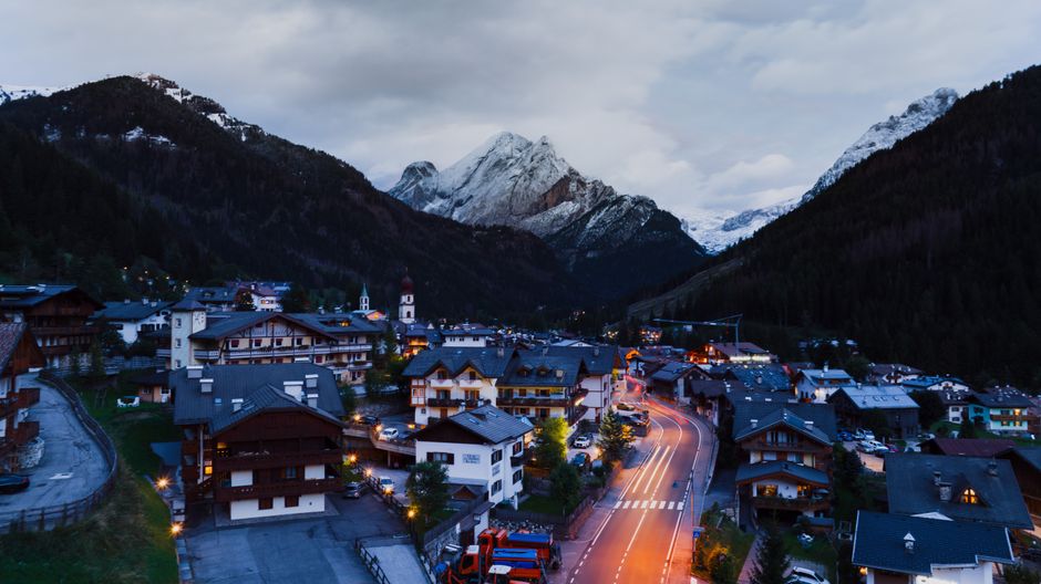 Quiet mountain town street at dusk after a fresh winter snowfall